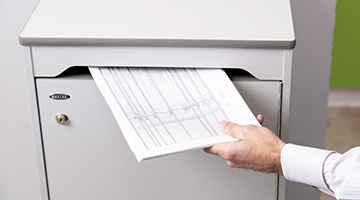 Documents being deposited into a console