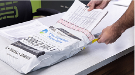 Documents being put into a shred vault bag