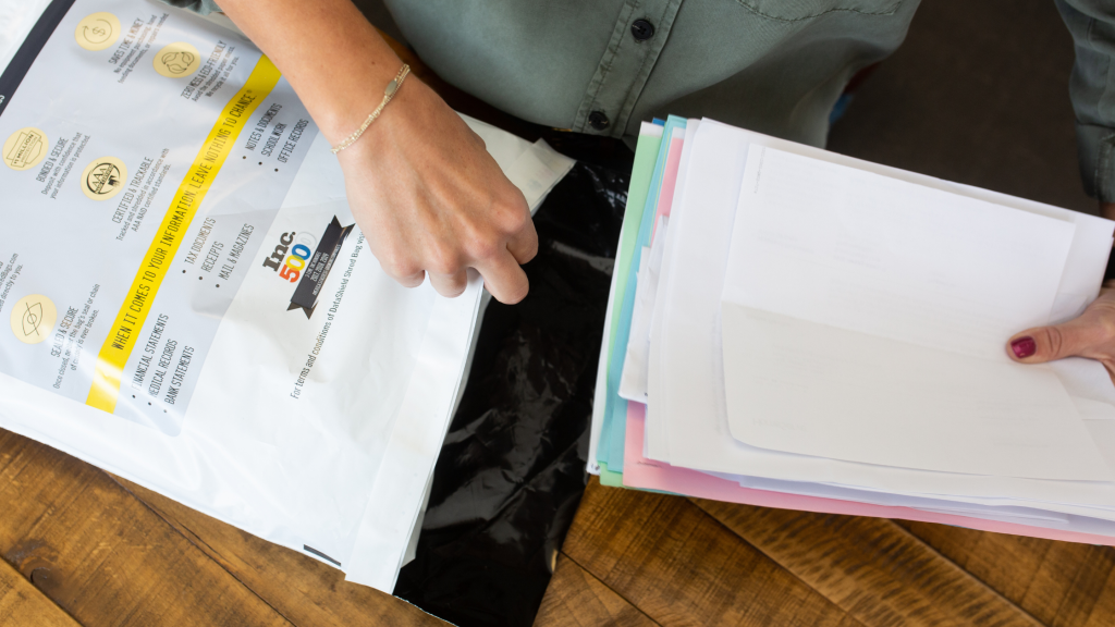 Woman Loads Documents into a Shred Vault Bag